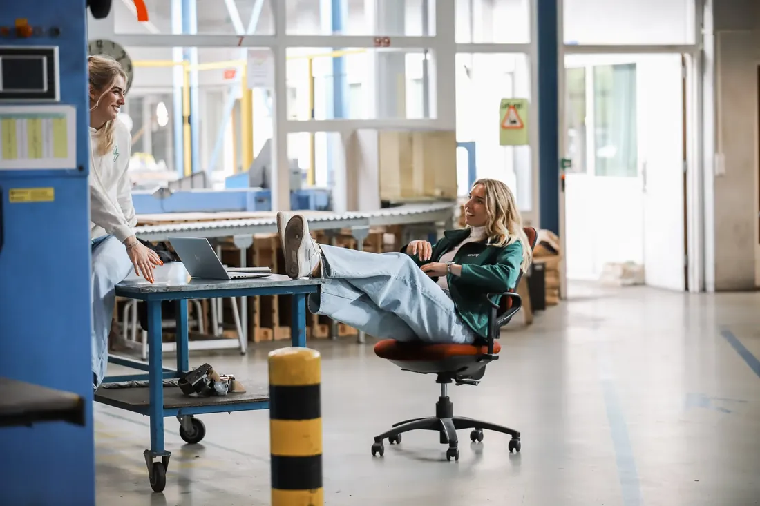 Feet up at a desk in the middle of the hall