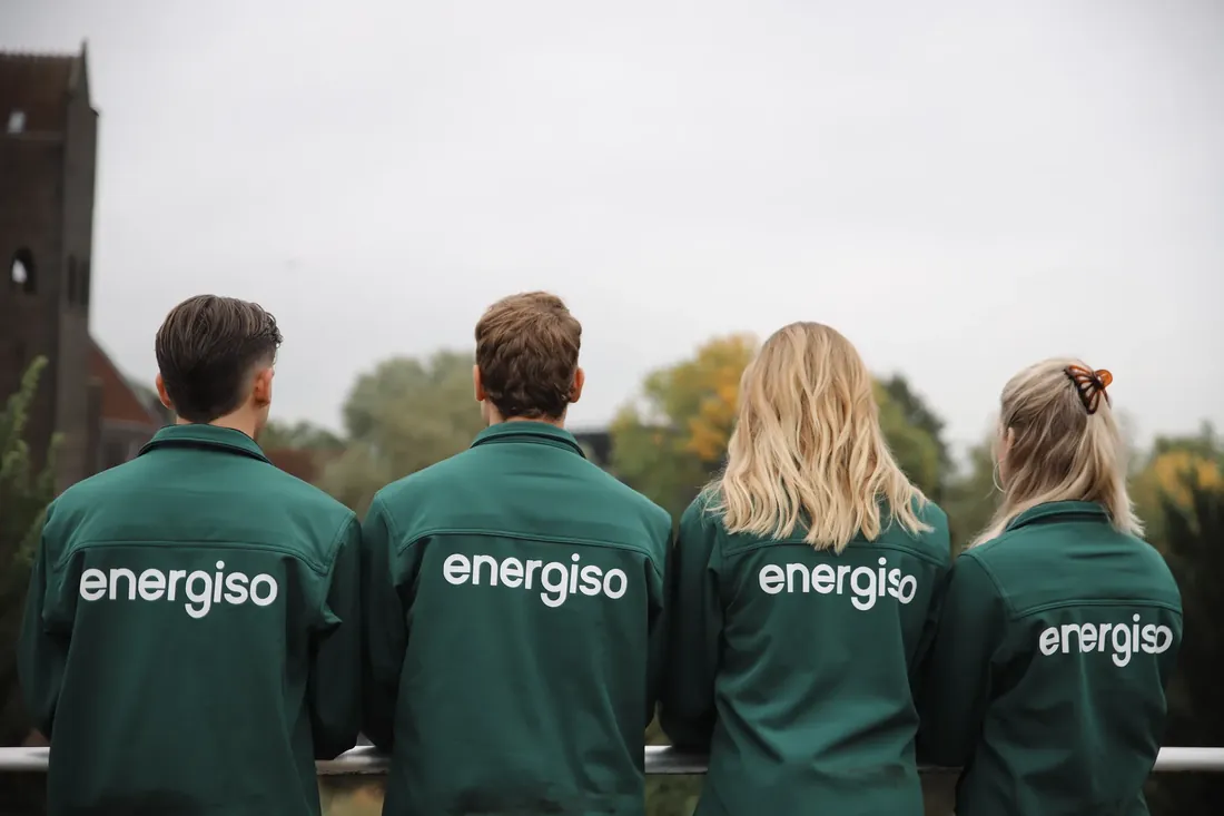 The team from behind, in their green jackets