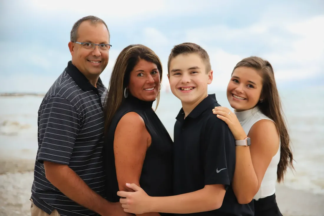 The whole family on the beach, cheek to cheek