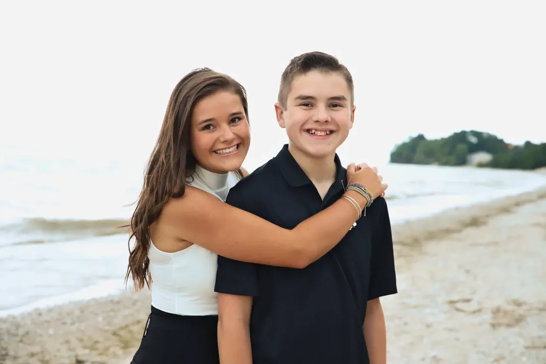 A big sister’s hug on the beach