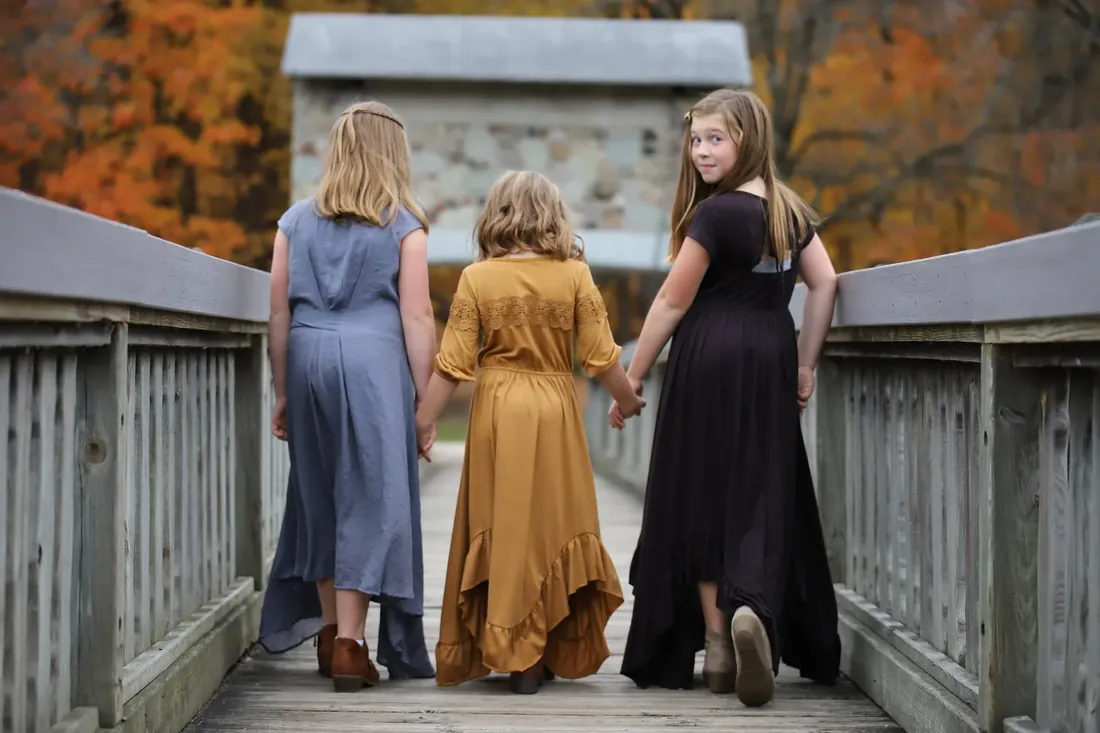 Three sisters on the bridge, one looking back