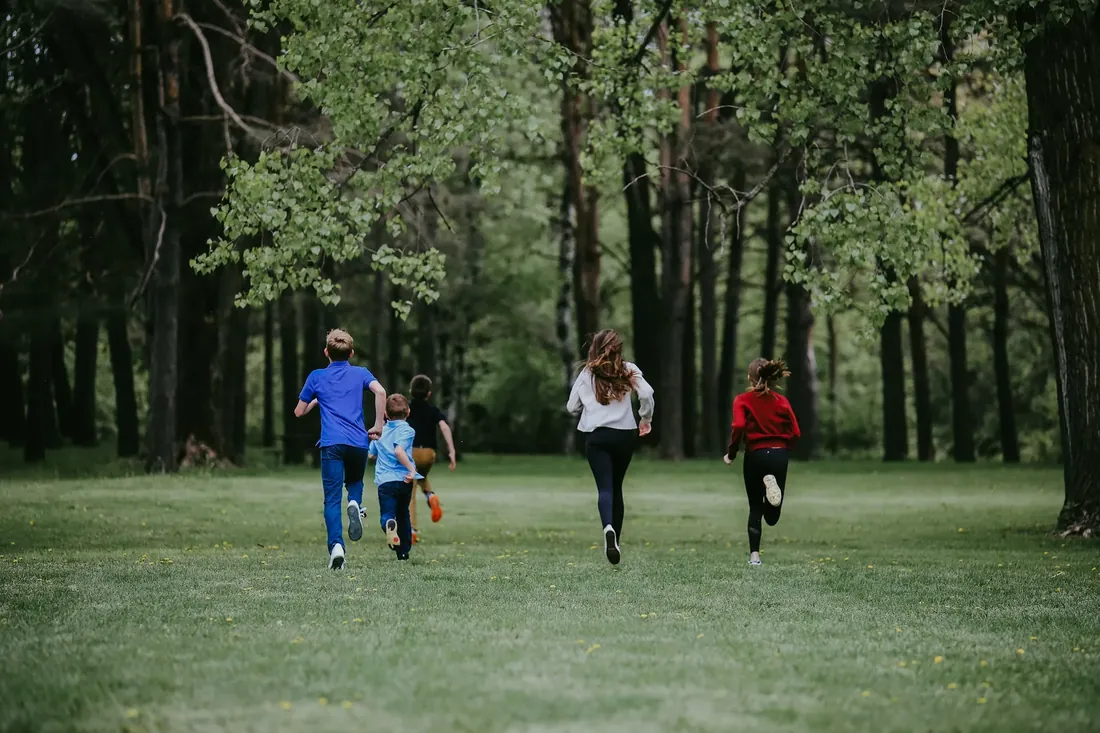 Racing across the field to the trees