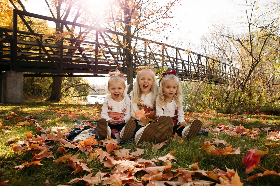 Three sisters in the leaves under the bridge