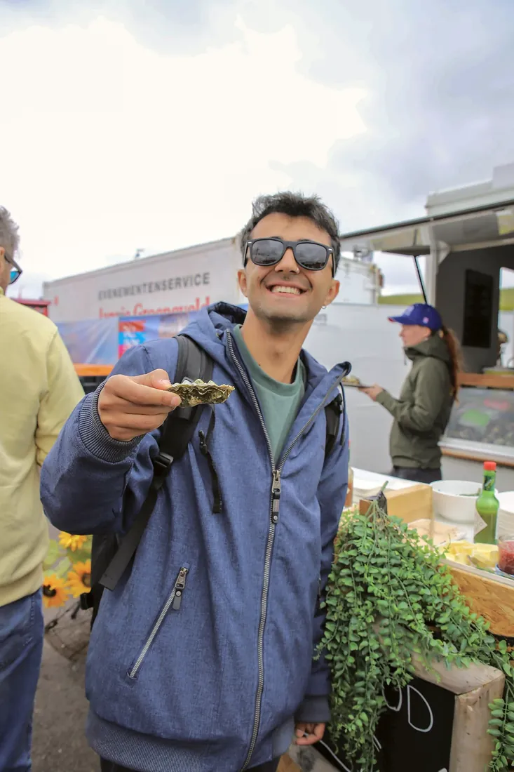 Trying an oyster at the harbour festival
