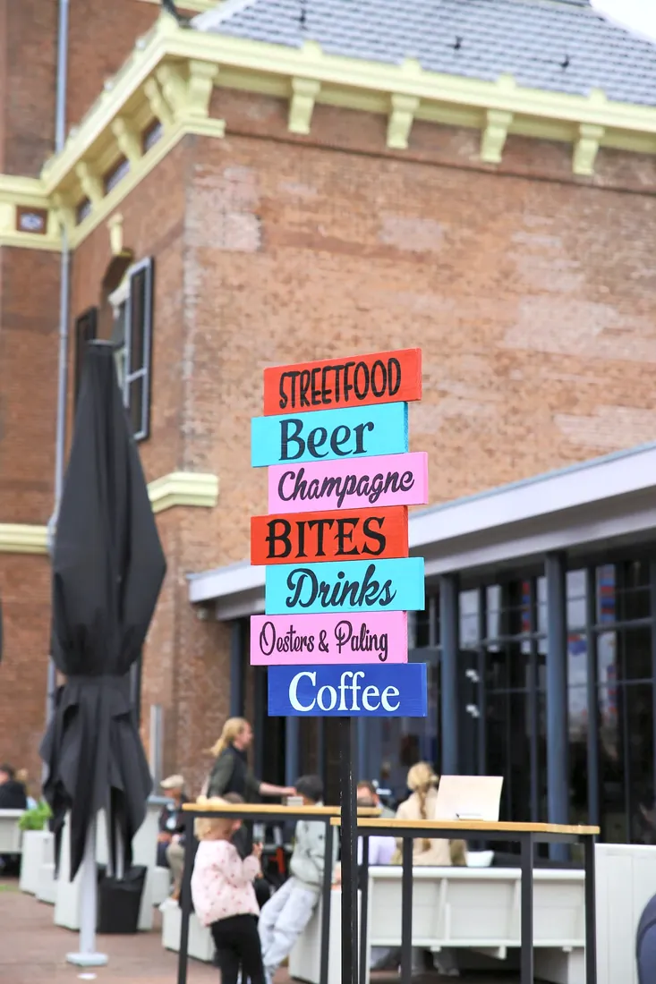 A sign for street food, oysters and eel