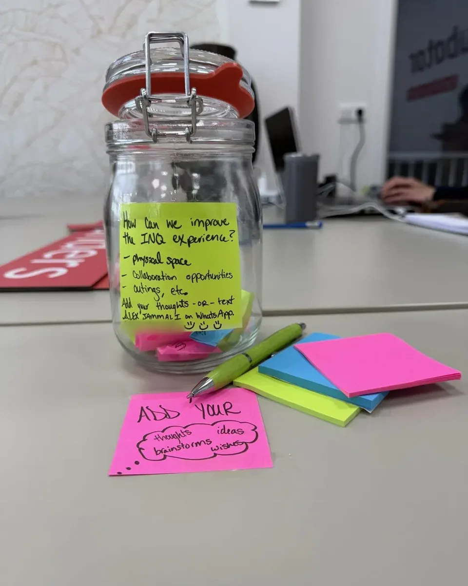 Inqubator in 5 photos: the feedback jar, members on the city beach, the first Lunch & Learn, a Friday drinks note and a 2027 goal bottle