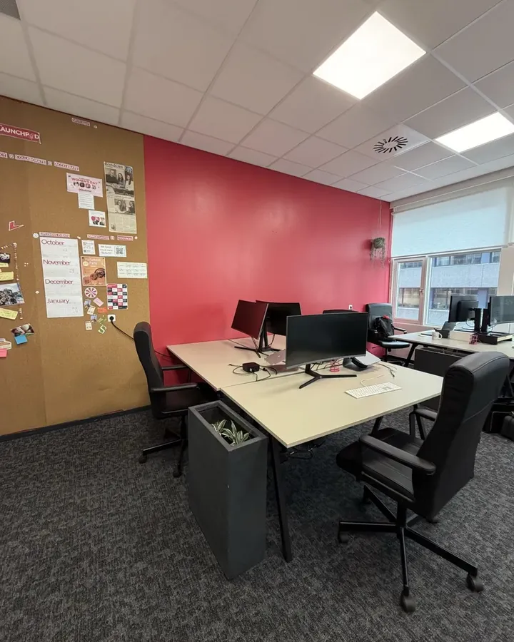 The room now, with a red wall and the corkboard Launchpad