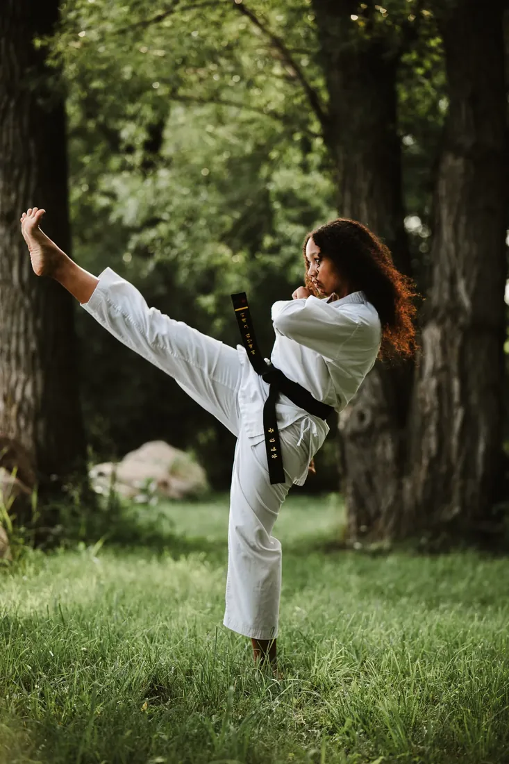 Black belt: A high kick between the trees