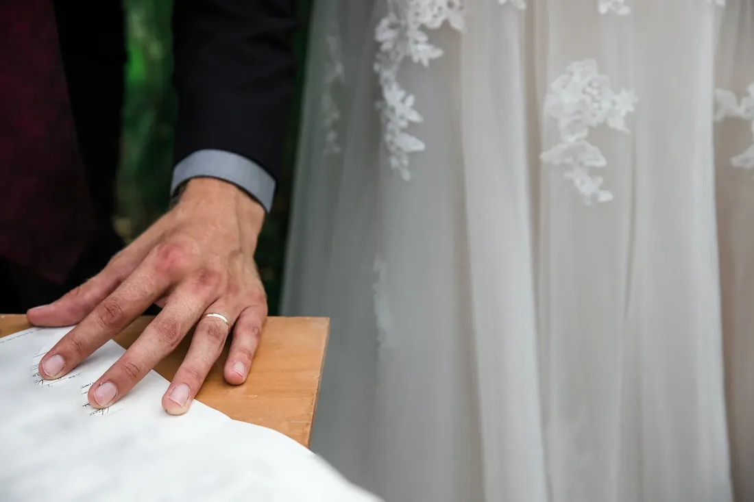 Amanda & Jack: his hand on the marriage license