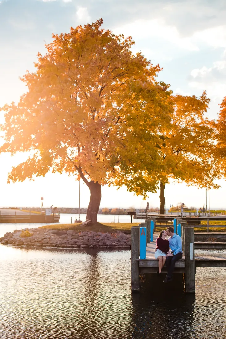 Nancy & Alex: the tree lit from behind, the 2 of them small on the dock