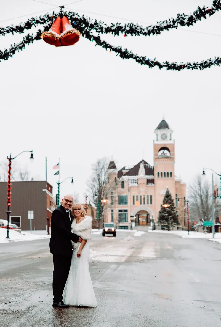 Patty & Craig: in the middle of the street, garland and bells overhead