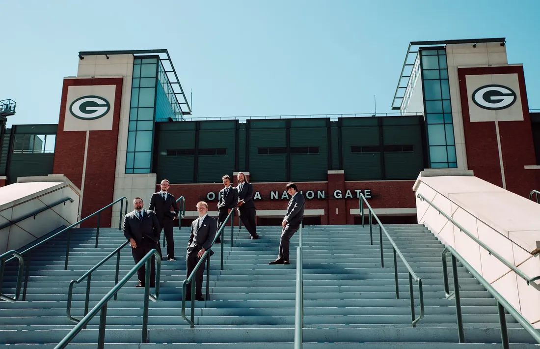Trisha & Mark: the groomsmen on the Lambeau steps