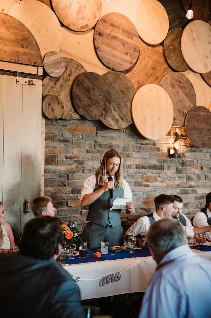 Trisha & Mark: a speech under the wall of wooden rounds
