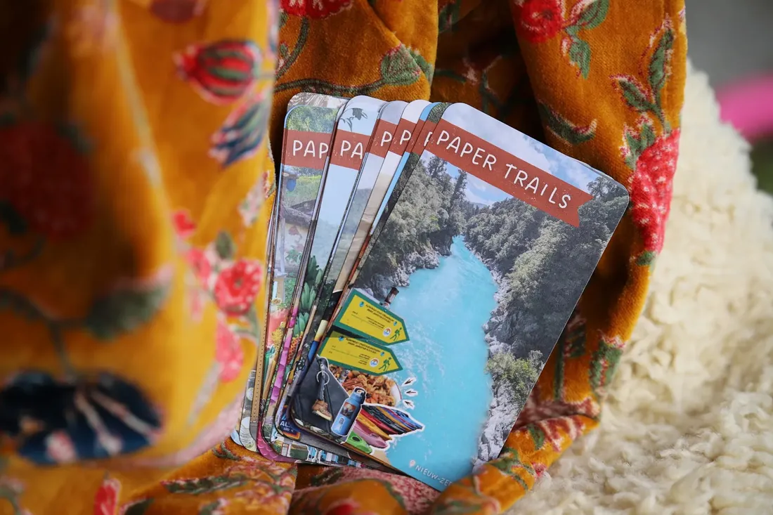 Cards fanned out on an orange floral cloth