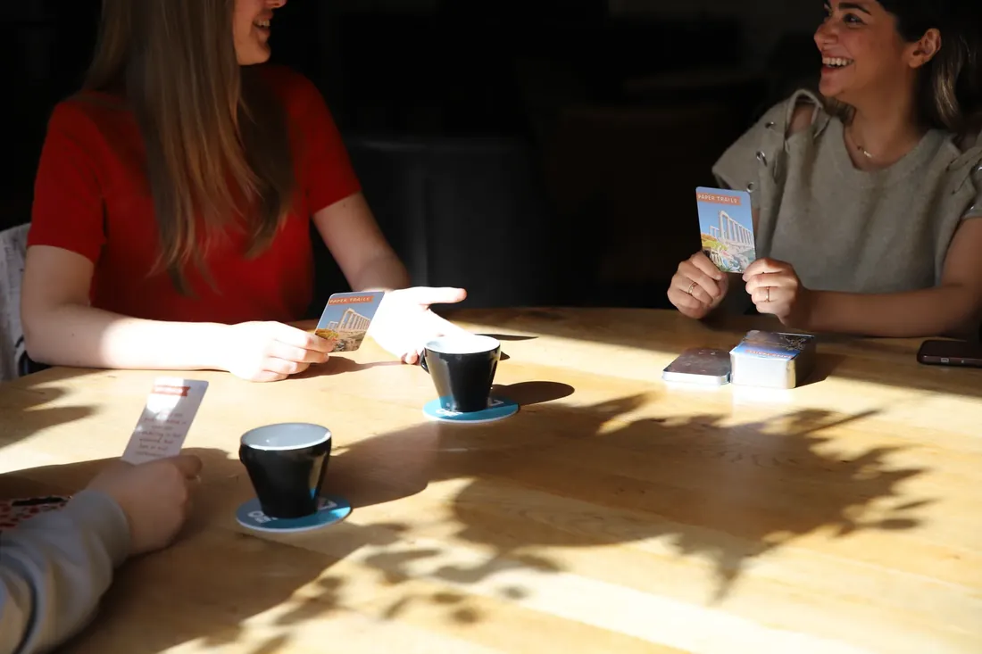Laughing over the cards at a sunny table