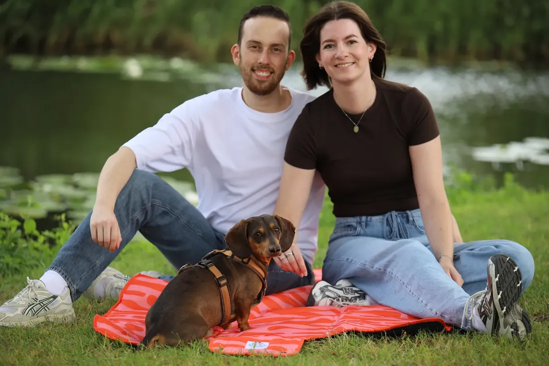 Robert and Emma with their dachshund on the coral mat