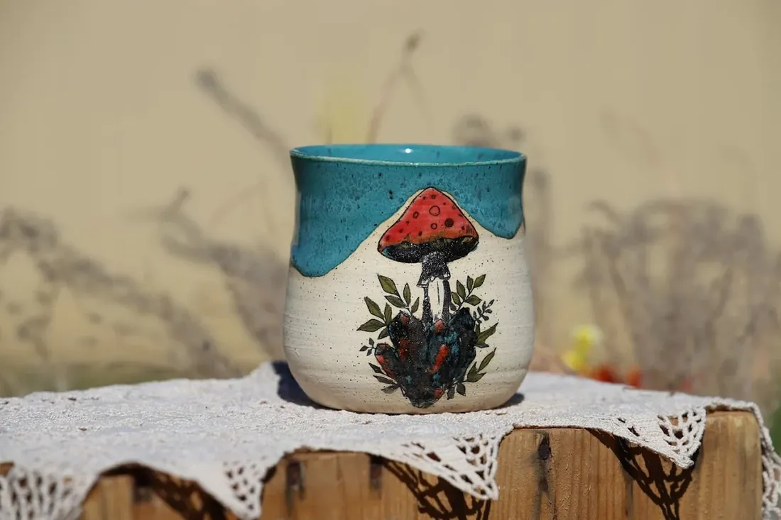 A mug with a painted mushroom