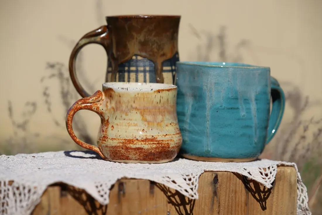 A pitcher and 2 mugs side by side