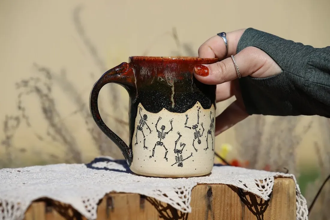 A mug with dancing skeletons, from the holiday set