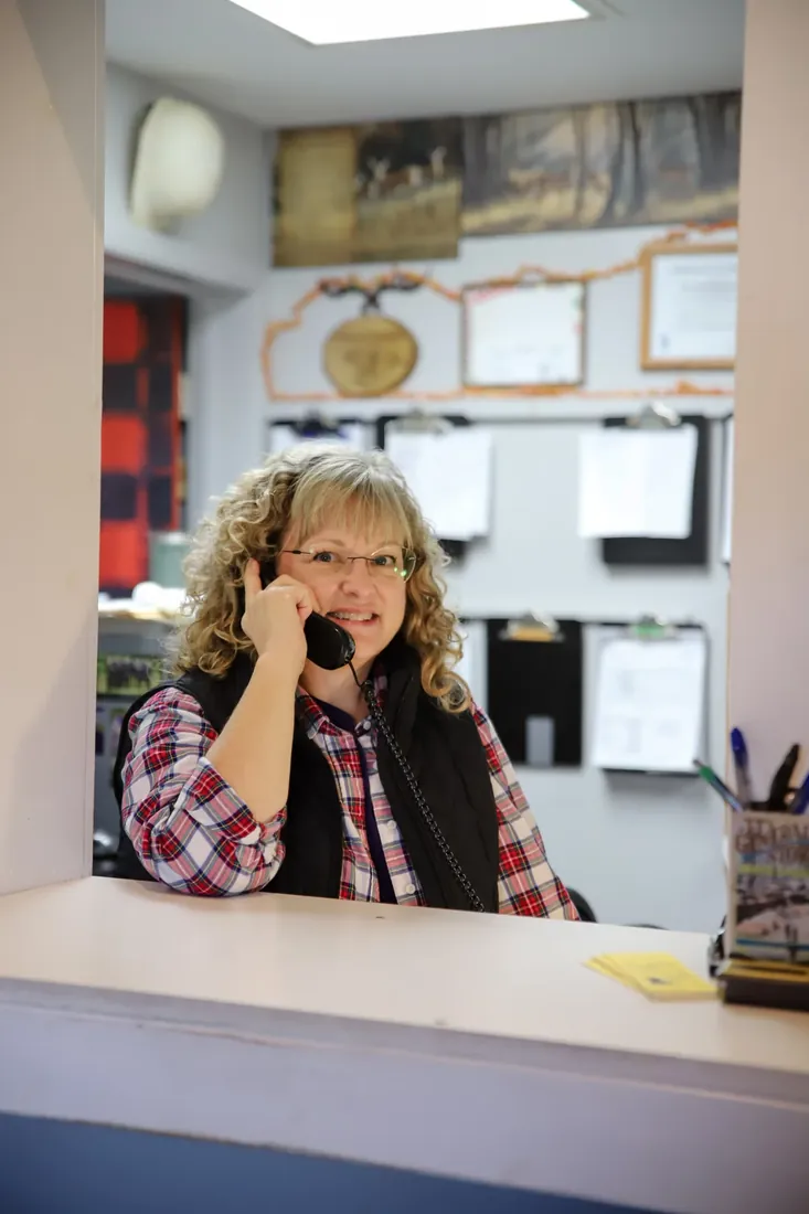 Taking an order on the phone at the front counter
