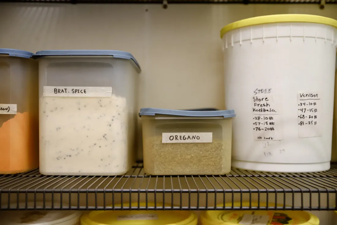 Spice tubs on the shelf, labelled by hand