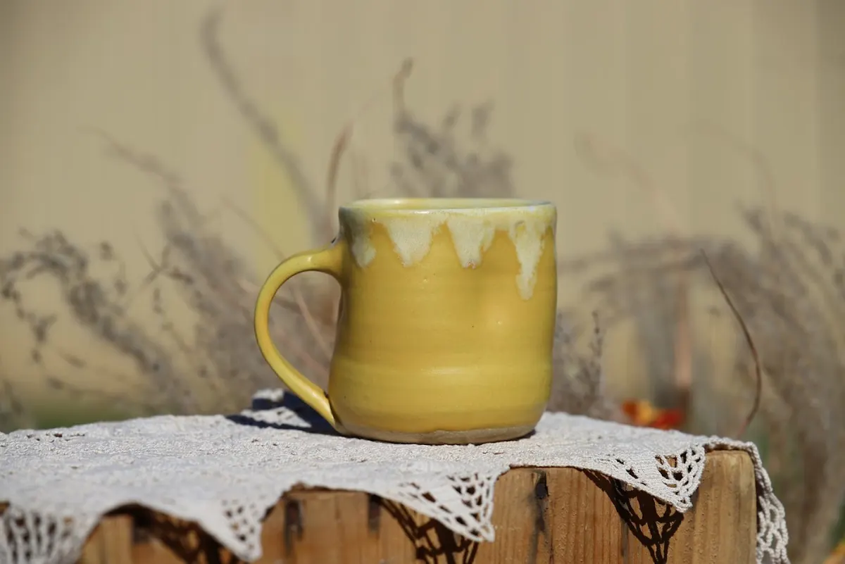 Stop-motion of Abby’s handmade mugs, one after another, on the same scrap of lace outdoors
