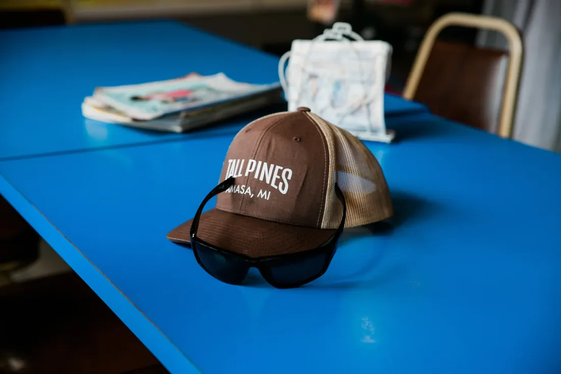A Tall Pines cap on the blue café table