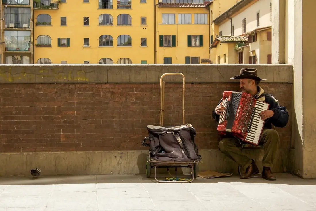 An accordion player under yellow walls, Italy