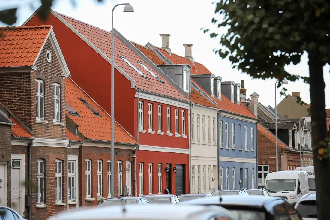 A row of painted houses and red roofs