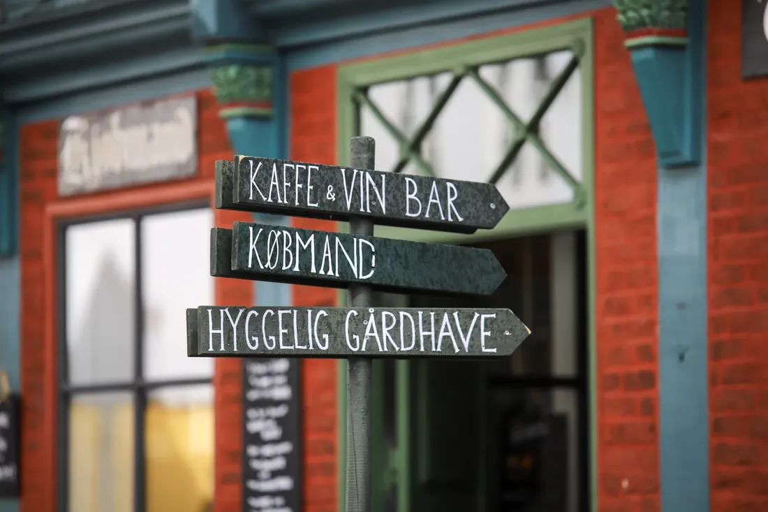 Signposts to coffee, wine and a cozy courtyard