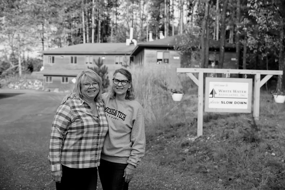Out front by the please-slow-down sign, the lab behind them