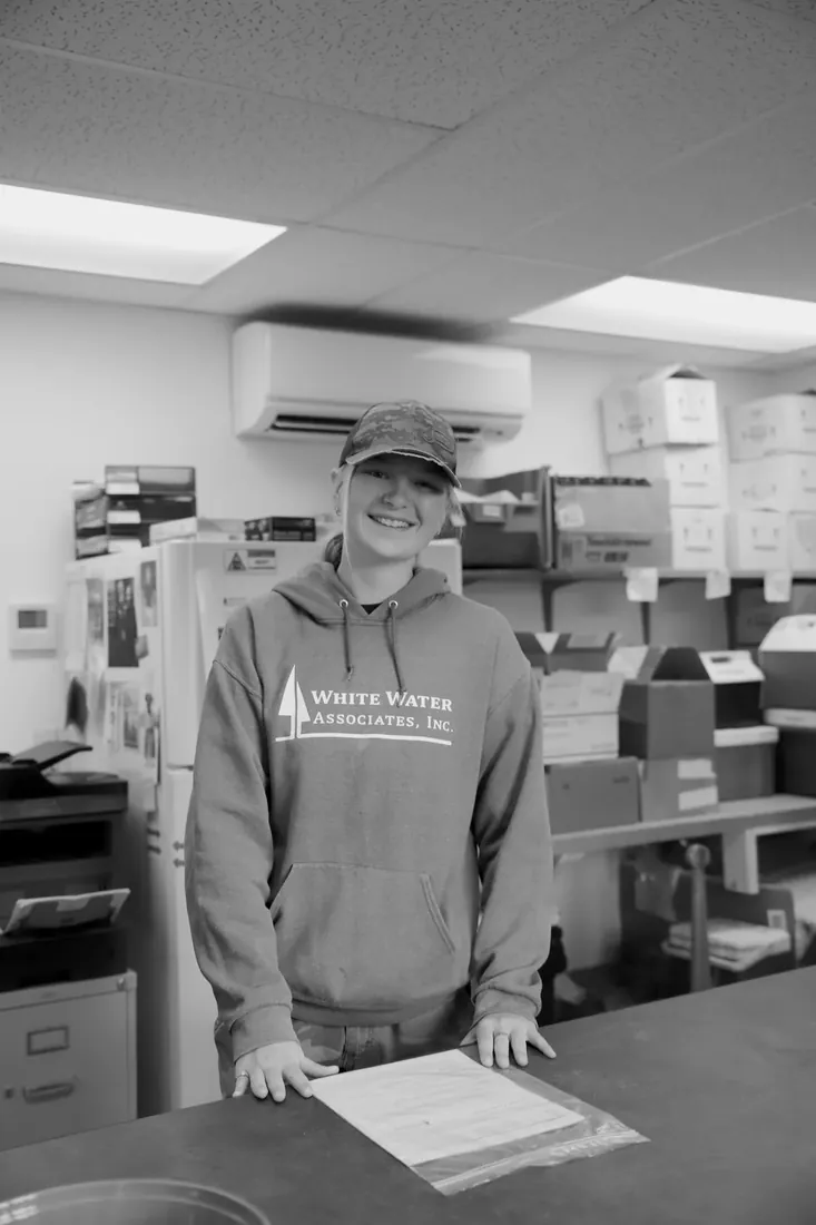 At the receiving counter in a White Water hoodie