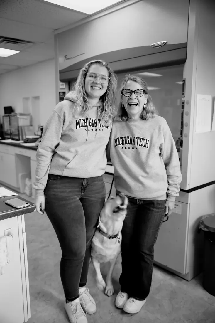 Matching Michigan Tech sweatshirts and the office dog