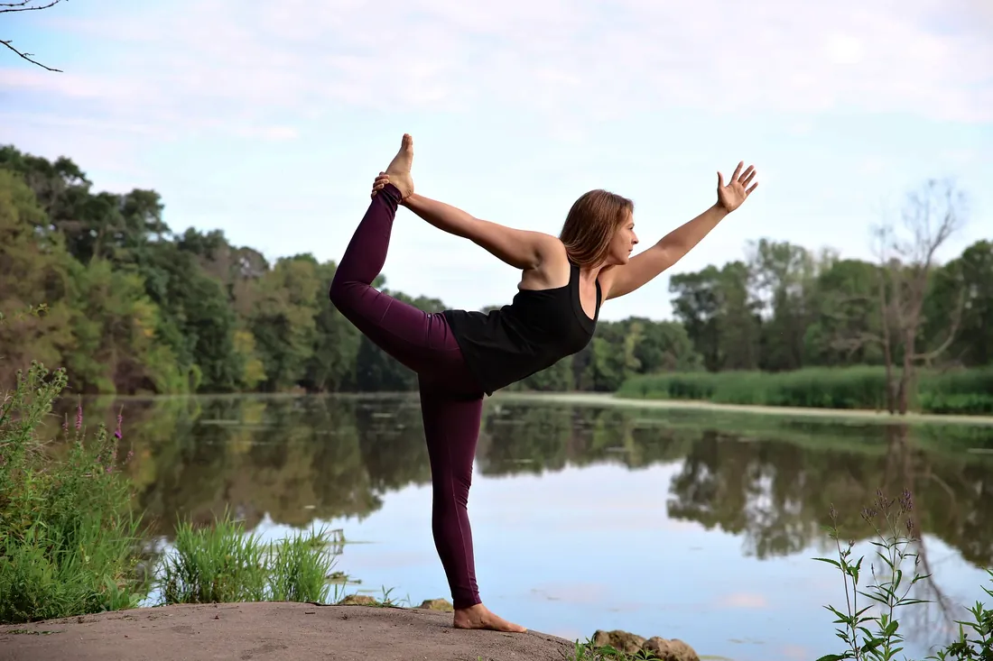 Yoga by the lake: Dancer pose with the lake behind her