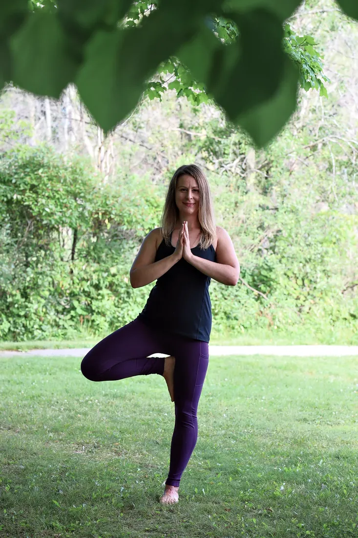 Yoga by the lake: Tree pose under the leaves