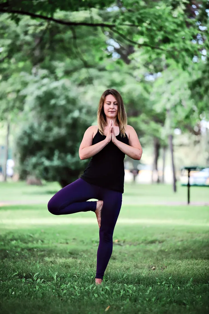 Yoga by the lake: Tree pose in the park